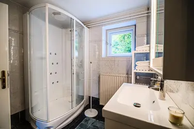 a bathroom with a shower and a sink at Parkside Haven with 4 Bedrooms & free parking in Ljubljana