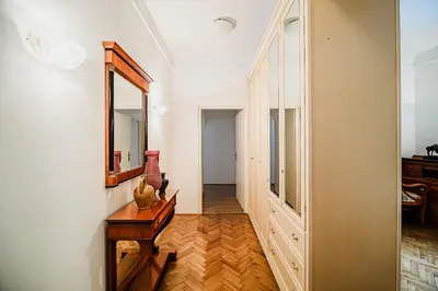 a hallway with a mirror and a wooden table at Parkside Haven with 4 Bedrooms & free parking in Ljubljana