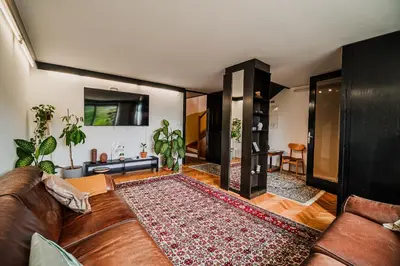 a living room with a couch and a rug at Parkside Haven with 4 Bedrooms & free parking in Ljubljana