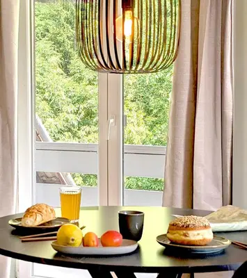 two plates of food on a table with a window at Green Heart Suites in Podljubelj