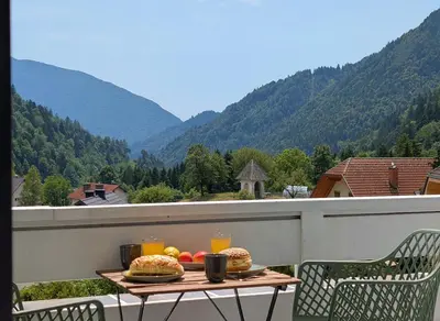a table with food and drinks on a balcony at Green Heart Suites in Podljubelj