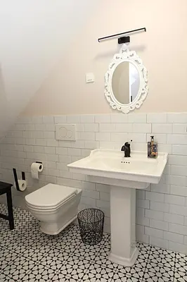 a white bathroom with a sink and a toilet at D Rooms in Ljubljana