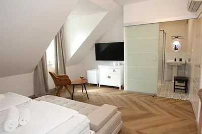 a hotel room with a bed and a tv at D Rooms in Ljubljana