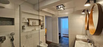 a bathroom with a sink and a mirror at Riva Residence in Old Town Ljubljana by the Cobblers' Bridge in Ljubljana
