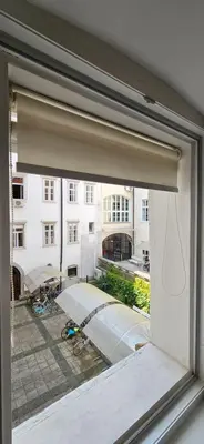 an open window with a view of a building at Riva Residence in Old Town Ljubljana by the Cobblers' Bridge in Ljubljana