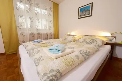 a bedroom with a bed with towels on it at Apartma PR ČEHC in Tolmin