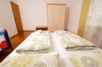 two beds in a small room with at Apartma PR ČEHC in Tolmin