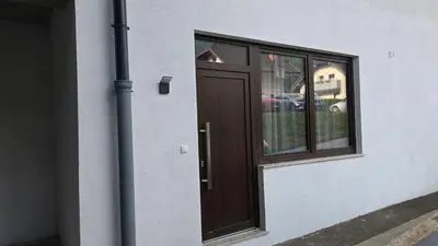 a wooden door on a building with a window at Apartma Alja 4 Kranjska Gora in Kranjska Gora