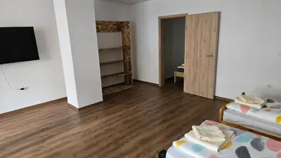 a room with a bed and a tv and a closet at Apartma Alja 4 Kranjska Gora in Kranjska Gora