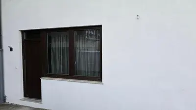 a window on the side of a white building at Apartma Alja 4 Kranjska Gora in Kranjska Gora