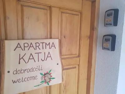 a sign on a door that readsarma kattaadi doorbush welcome at Apartments Katja in Kranjska Gora