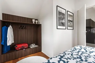 a bedroom with a bed and a red suitcase at AvantGarden in Bled