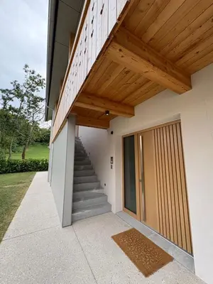 a house with a wooden roof and a staircase at AvantGarden in Bled