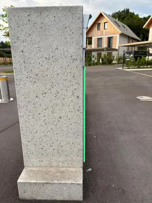 a stone pillar in the middle of a parking lot at AvantGarden in Bled