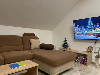 a living room with a couch and a flat screen tv at Zerko Holiday Apartment Janko with JACUZZI and SAUNA in Mirna
