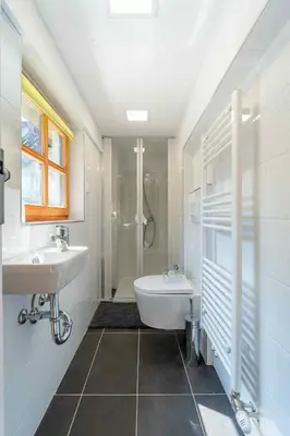 a bathroom with a sink and a tub and a shower at Apartma Špelca in Bohinj