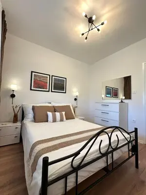a bedroom with a bed and a ceiling fan at Adria Apartment in Spodnje Škofije