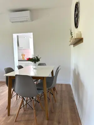 a dining room with a table and chairs at Adria Apartment in Spodnje Škofije
