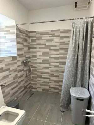 a bathroom with a shower and a toilet and a sink at Adria Apartment in Spodnje Škofije