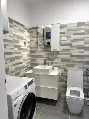 a bathroom with a washing machine and a sink at Adria Apartment in Spodnje Škofije