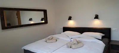 a bedroom with two beds with towels on them at Apartmaji Božiček in Podčetrtek
