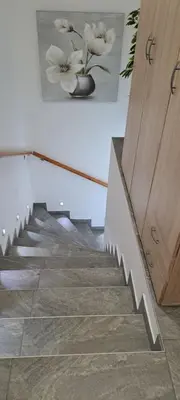 a staircase with a picture of flowers on the wall at Apartmaji Božiček in Podčetrtek