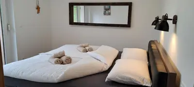 a room with a bed with two babies on it at Apartmaji Božiček in Podčetrtek