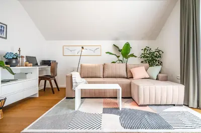 a living room with a couch and a table at Strato Apartment in Kočevje
