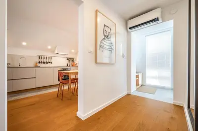a kitchen and dining room with a table and chairs at Strato Apartment in Kočevje