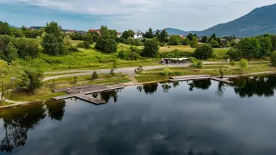 an aerial view of a lake with a bridge at Strato Apartment in Kočevje