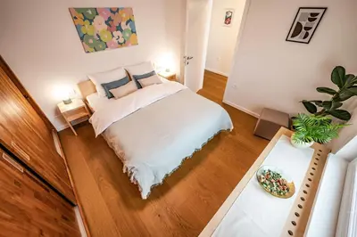 a bedroom with a bed and a potted plant at Strato Apartment in Kočevje