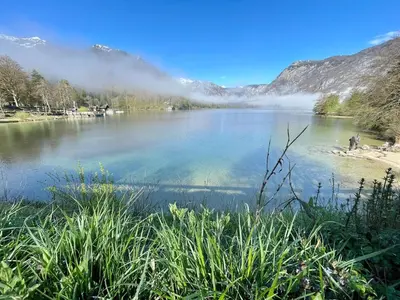 a view of a lake with mountains in the background at Vacation cottage house Enya in Koprivnik v Bohinju