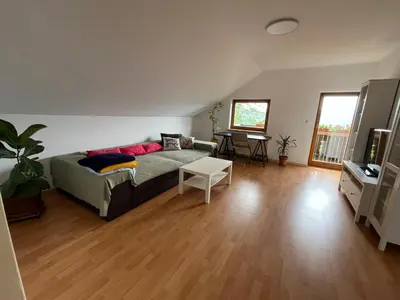 a living room with a couch and a table at Apartma Mohorič in Idrija