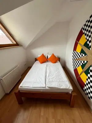 a small bedroom with a bed in a attic at Apartma Mohorič in Idrija