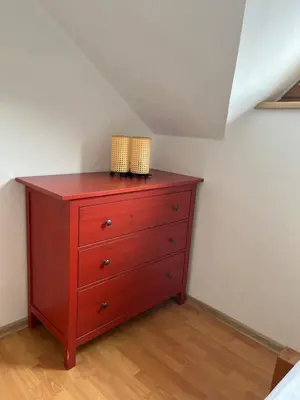 a red dresser in a room with a attic at Apartma Mohorič in Idrija