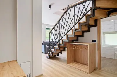 a staircase in a house with a wooden box at Hiša PolajnArh in Bohinj