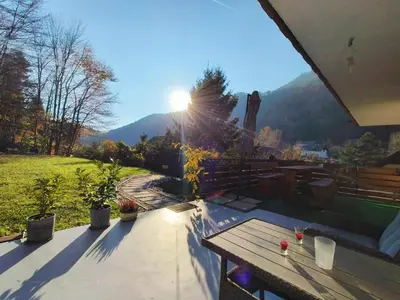a patio with a table and a view of a mountain at Apartment Magnolia in Blejska Dobrava