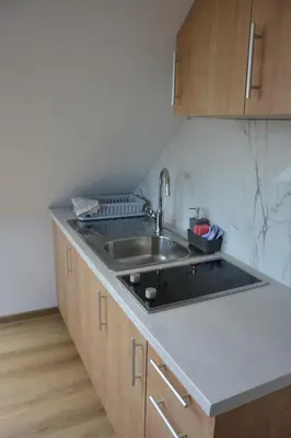 a kitchen with a sink and a counter top at Apartma Rebeka in Zgornje Gorje