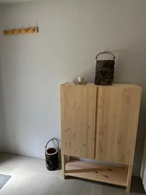 a wooden cabinet with two baskets on top of it at Pinus Alpinus Apartments in Bovec
