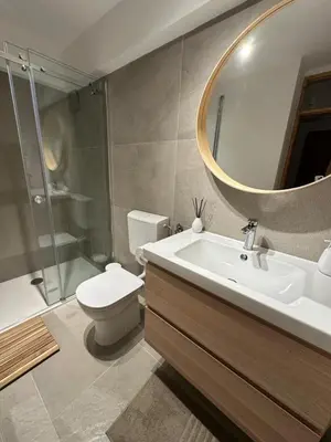 a bathroom with a sink and a toilet and a mirror at Pinus Alpinus Apartments in Bovec