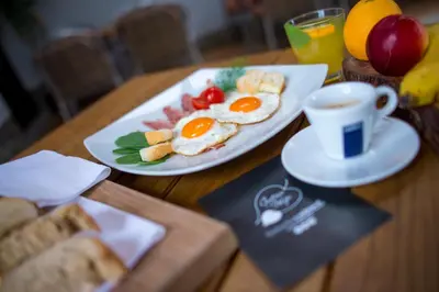 a table with a plate of eggs and a cup of coffee at Gostisce Ulipi in Slovenske Konjice