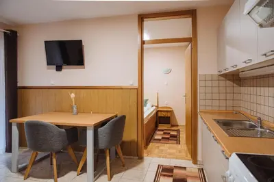 a small kitchen with a wooden table and chairs at Gostisce Ulipi in Slovenske Konjice