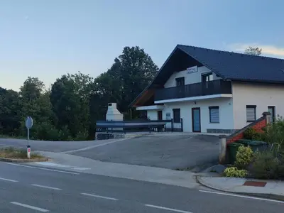 a building on the side of a road at Družinski apartmaji Judnič in Adlešiči