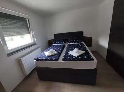 a bed in a room with two pillows on it at Družinski apartmaji Judnič in Adlešiči