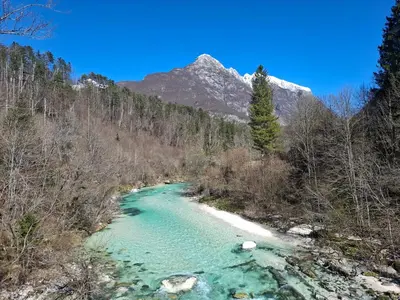 a river with a mountain in the background at Kamer Luna in Log Čezsoški