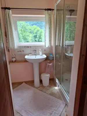 a bathroom with a sink and a shower at Kamer Luna in Log Čezsoški