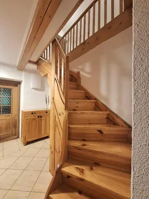 a wooden staircase in a room with a kitchen at Vila Anton in Dobrna