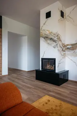 a living room with a fireplace and a painting on the wall at Holiday Home Kamence in Rogaška Slatina