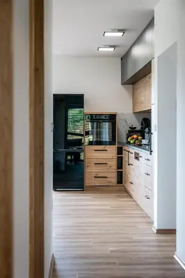 a kitchen with white walls and wooden cabinets at Holiday Home Kamence in Rogaška Slatina