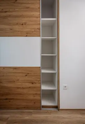 an empty closet with wooden doors and shelves at Holiday Home Kamence in Rogaška Slatina